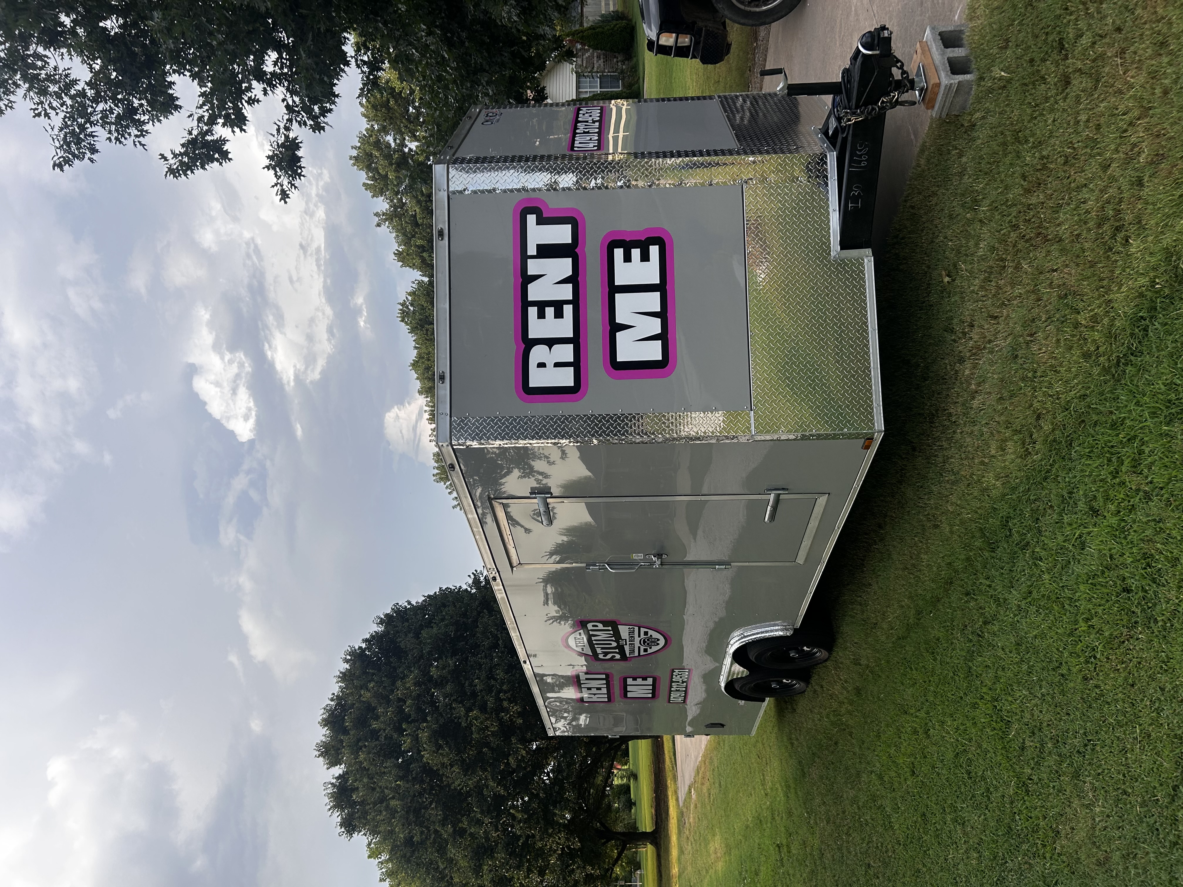 Enclosed "Rent Me" cargo trailer from The Stump LLC Trailer Rentals parked and ready to rent in Springdale, Arkansas